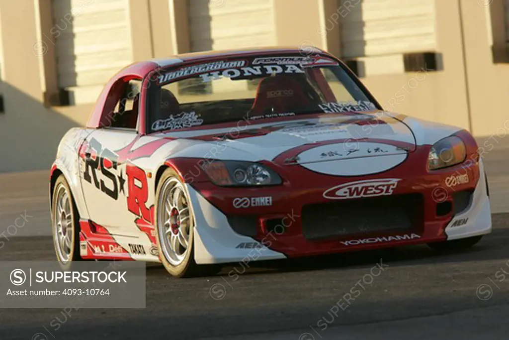 2004 Honda s2000 s-2000 Hardtop racing version race type   S2000 features a front-mid-engine, rear wheel drive layout with power being delivered via a Torsen limited slip differential mated to a six-speed manual transmission.  The S2000 comes with an electrically powered cloth top, and an OEM hardtop is also available.  The 2004 model introduced newly designed 17 wheels and Bridgestone RE-050 tires along with a retuned suspension that reduced the car's tendency to oversteer. The spring rates and