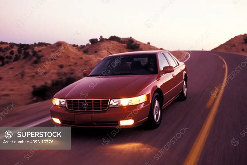 Cadillac Seville STS Northstar 2000 red headlights curve grainy street