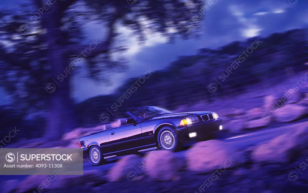 BMW 1998 323ic blue front 3/4 cross-processed asphalt trees rocks headlights 1990s street