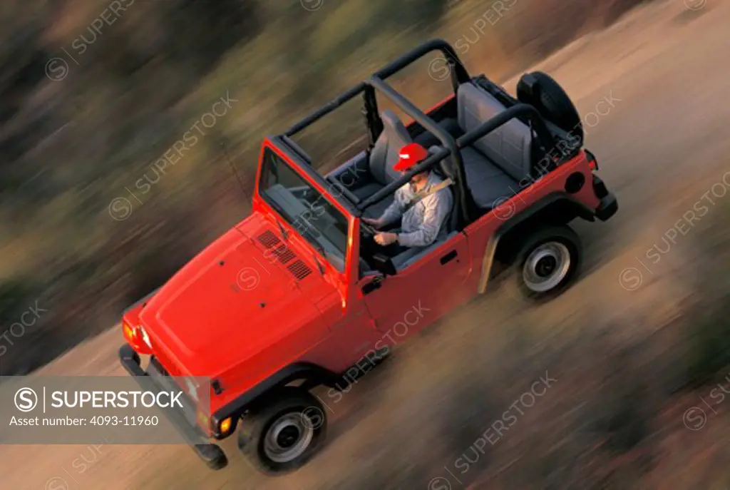 Jeep 1996 Wrangler 4x4 red overhead off-road man blur brush 1990s