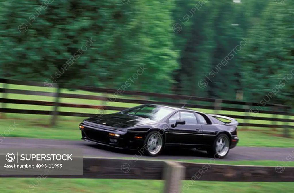 Lotus Esprit V8 1997 black fence trees 1990s street