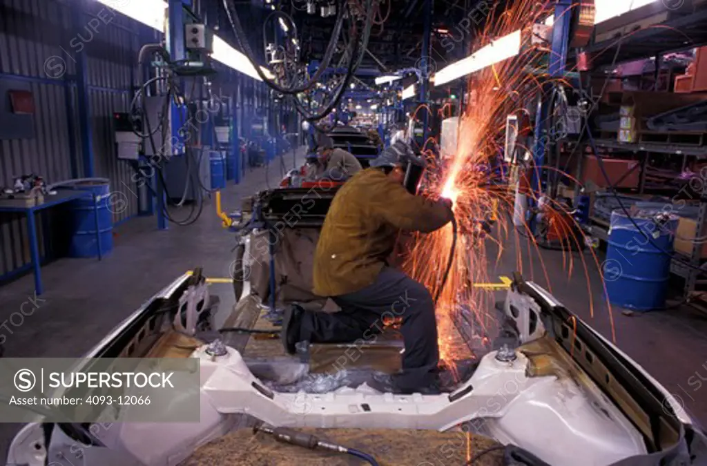 worker construction welding sparks flying body work inside