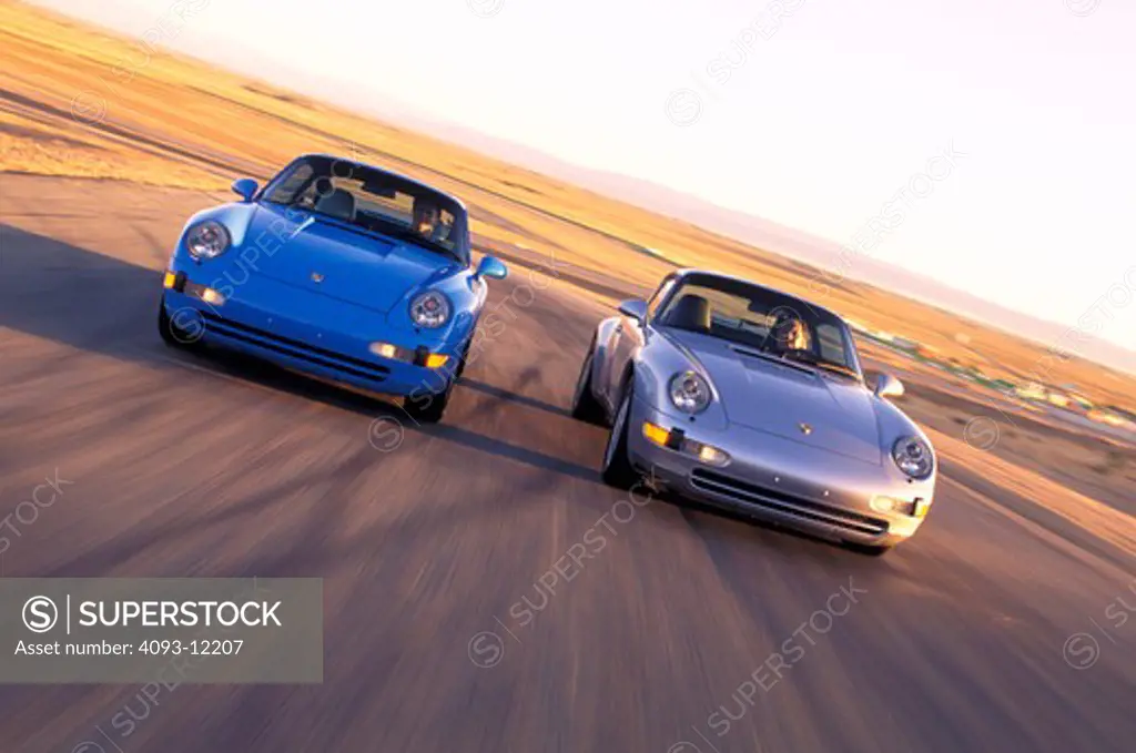 Porsche 911 Carrera 4 silver 911 Carrera 2 blue 1995 cars head on 1990s street