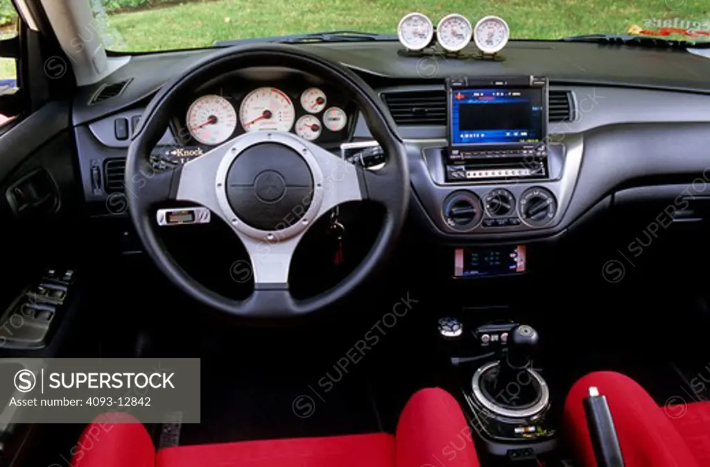 interior Mitsubishi Lancer Evolution 8 2004 steering wheel red seats dashboard black gauges