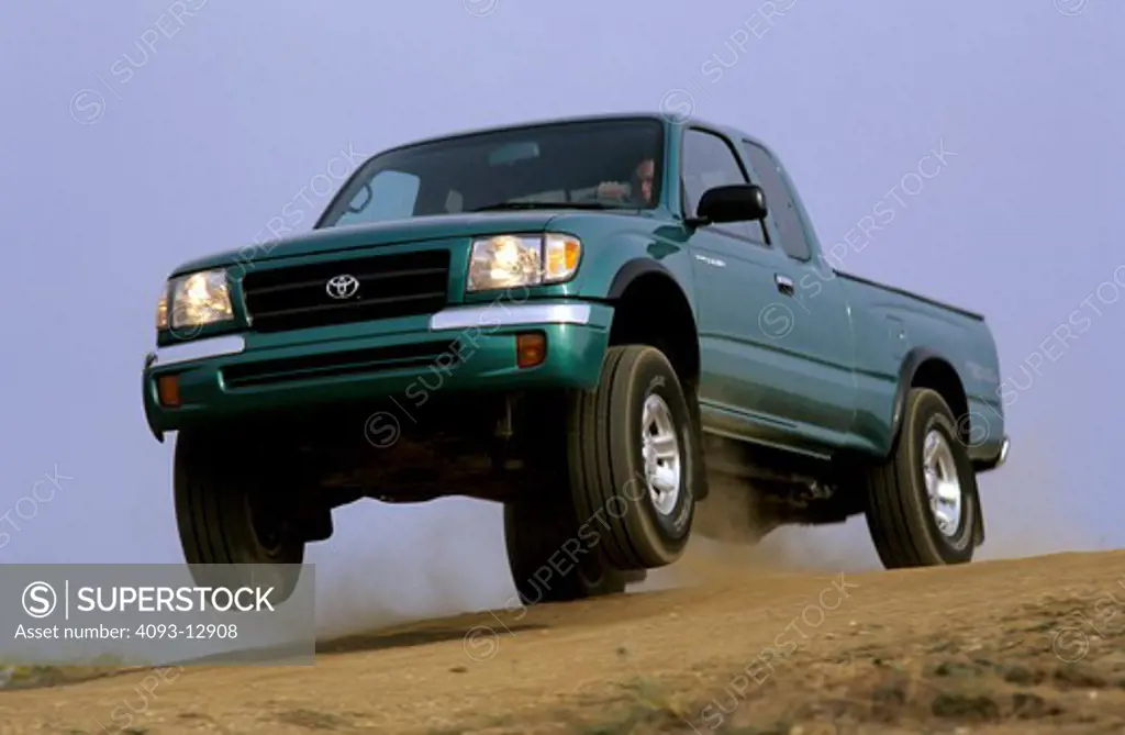 low angle Toyota Tacoma 1998 1990s green jump air