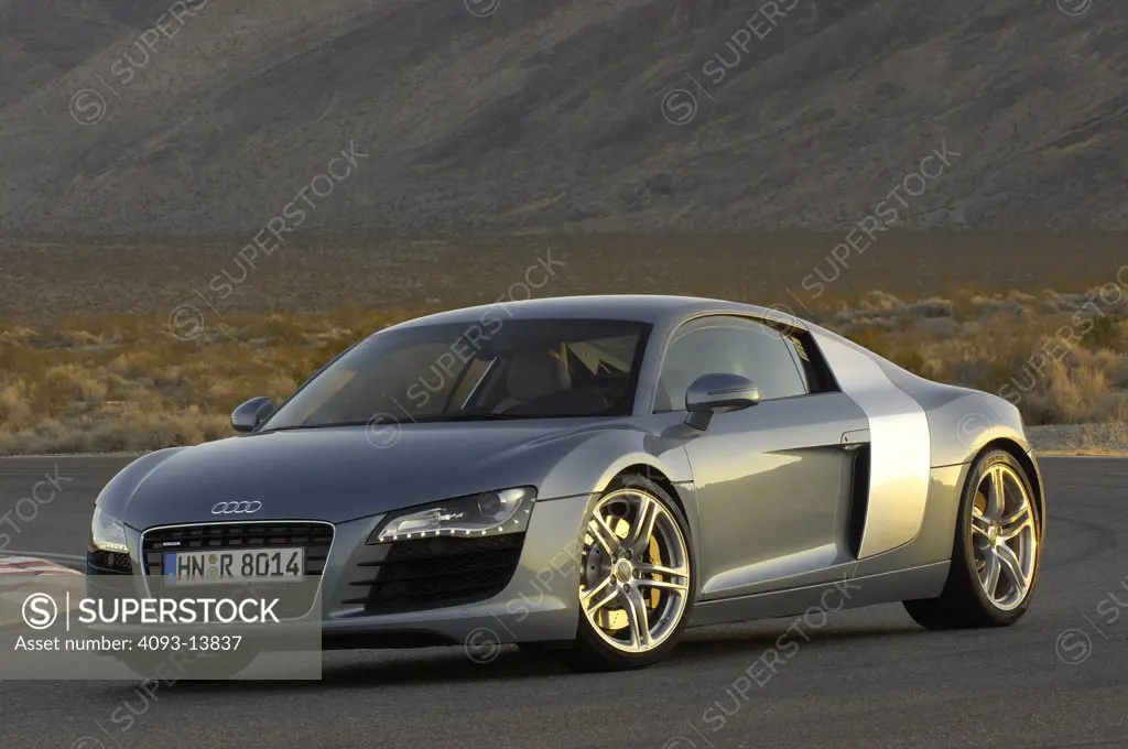 Audi R8, 2008 race track test drive empty road in the desert sun setting over the mpountains golden glowing on desert racetrack race track