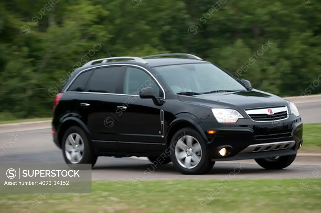Saturn Vue XR driving along road, side view