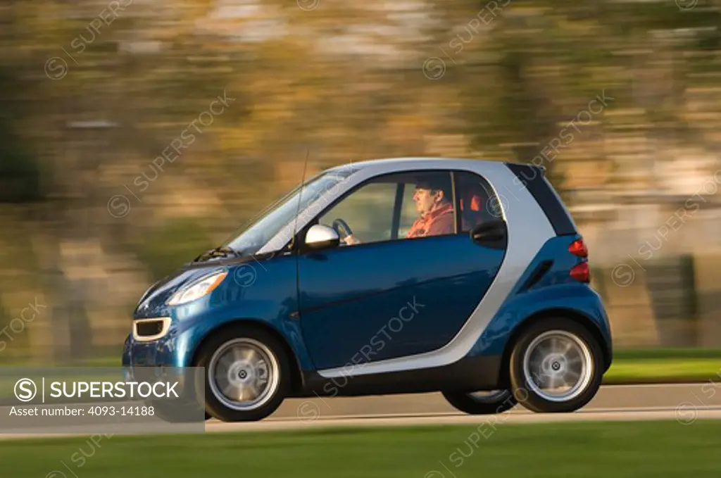 Smart ForTwo Passion Cabriolet driving along road, side view