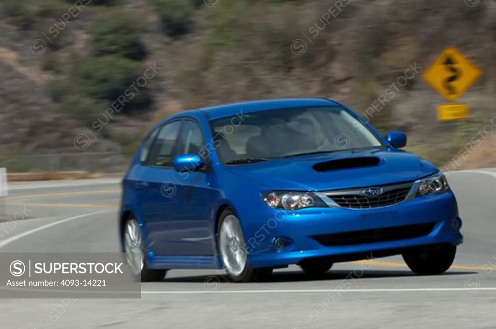 Subaru Impreza WRX driving along road