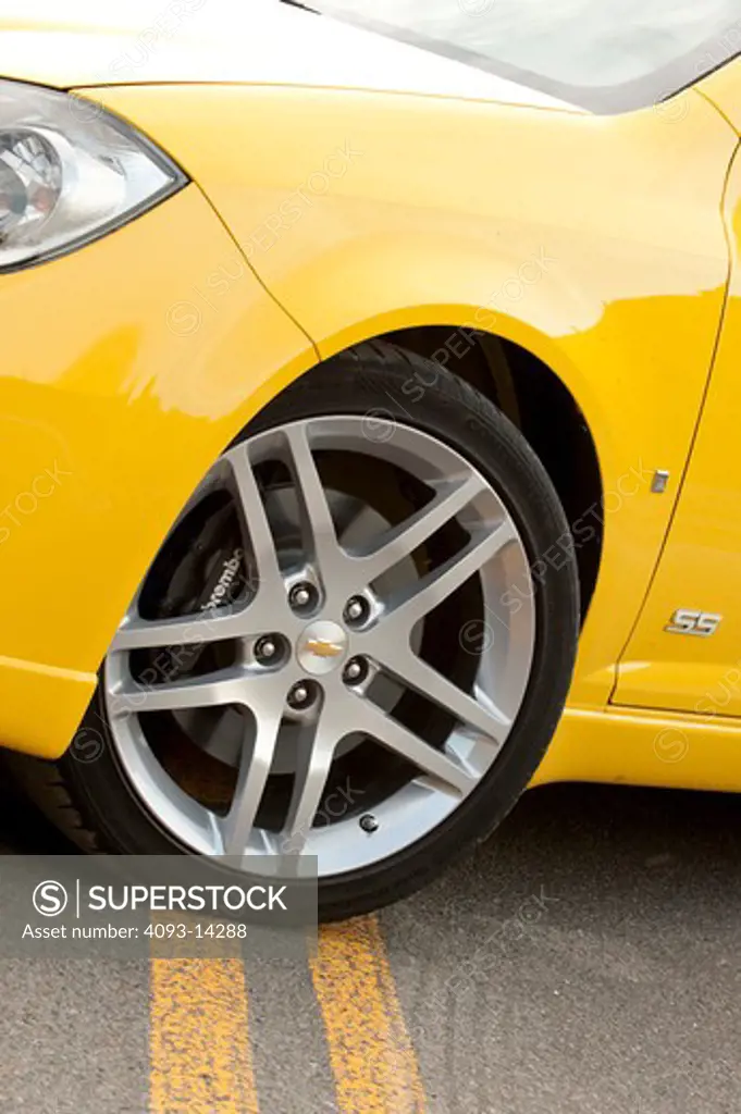 Yellow Chevrolet Cobalt SS side view of wheel