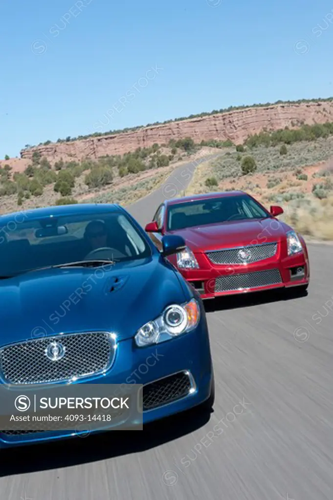 2009 Cadillac CTSV with Jaguar XF Type on road, front view