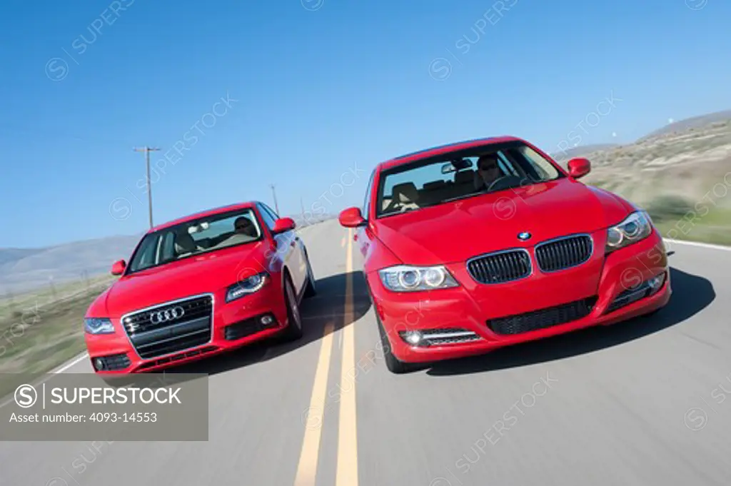 2009 BMW 335d and 2009 Audi A4 on the road, front view