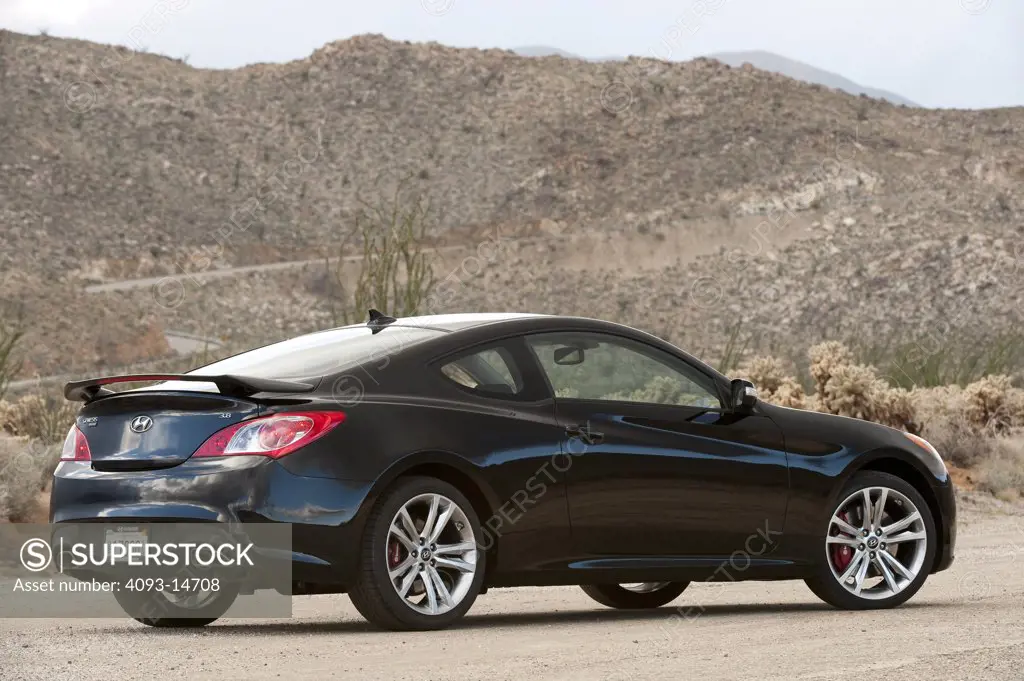 2010 Hyundai Genesis Coupe 3.8 V-6 on the road, rear 7/8