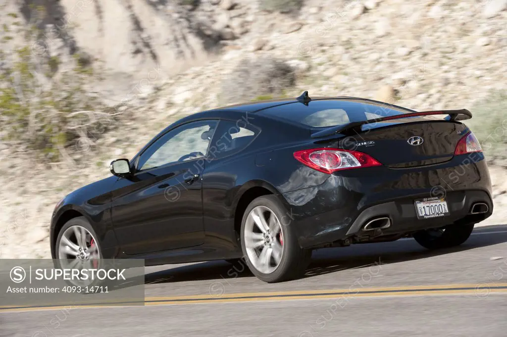 2010 Hyundai Genesis Coupe 3.8 V-6 on the road, rear 7/8