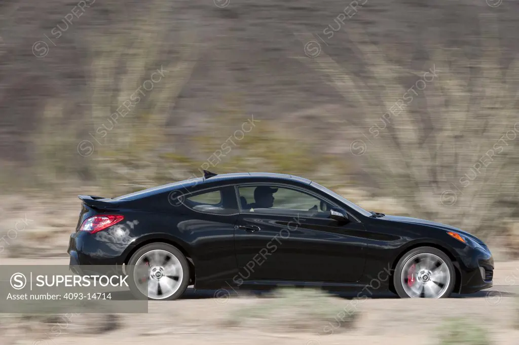 2010 Hyundai Genesis Coupe 3.8 V-6 on road, side view