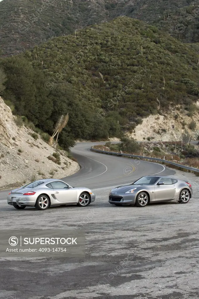 2009 Nissan 370Z and 2008 Porsche Cayman S on road, nose to nose, side view