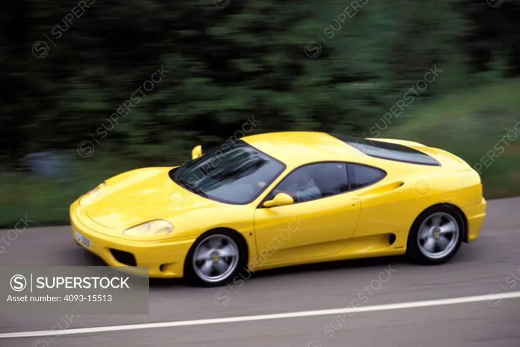 Ferrari 1999 360 Modena yellow front 3/4 profile asphalt trees 1990s street