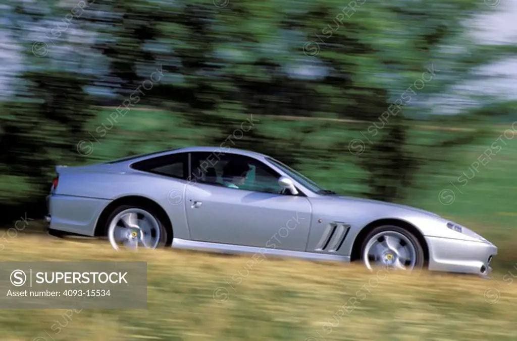 Ferrari 1997 550 Maranello silver profile dry grass trees blur 1990s