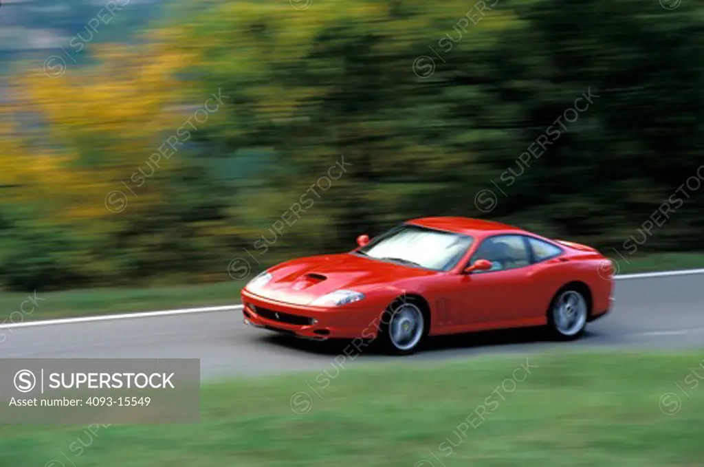 Ferrari 1997 550 Maranello red front 3/4 asphalt blur grass trees 1990s street