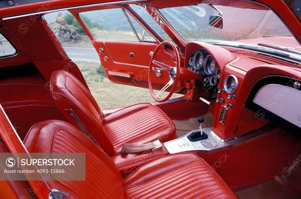 interior detail Corvette Stingray 1963 1960s red open doors leather seats gear shift steering wheel IP instrument panel