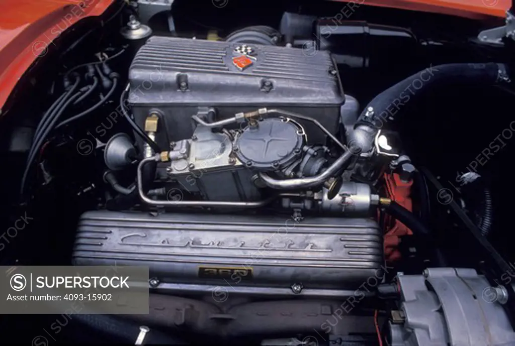 An engine detail of a 1963 Chevrolet Corvette Sting Ray / Stingray C2. 1960's . Showing the unusual intake manifold and fuel injection of this 327 cubic inch V8 motor / engine.
