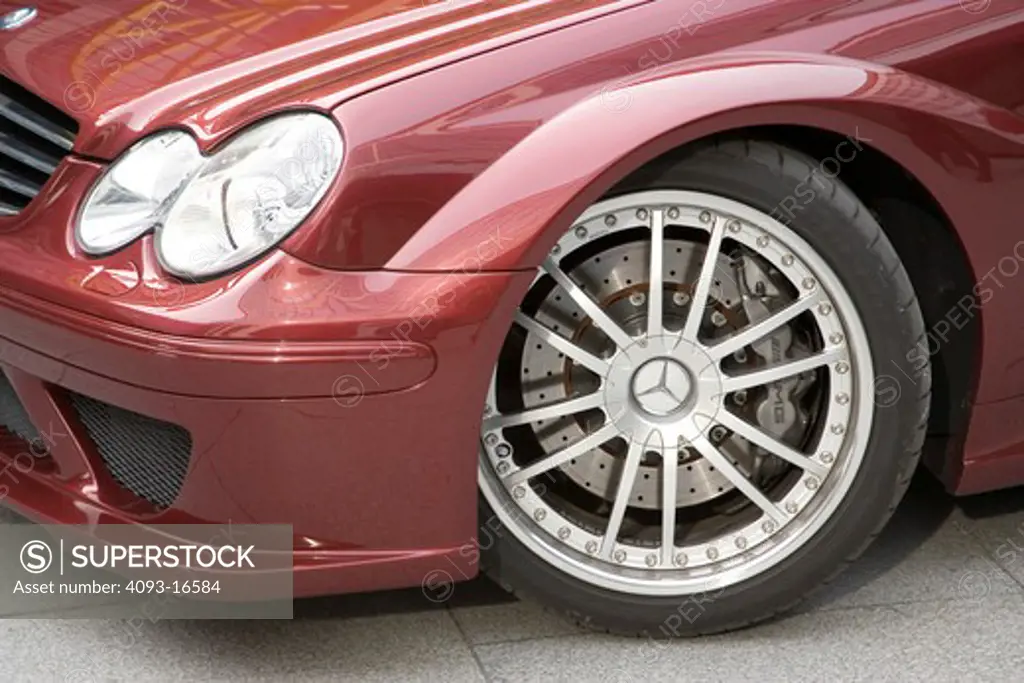 Detail view of a 2007 Mercedes-Benz AMG CLK DTM showing the left front wheel and headlights. A special version of the CLK is the CLK DTM AMG sports car using AMG's supercharged 5.4 L V8.