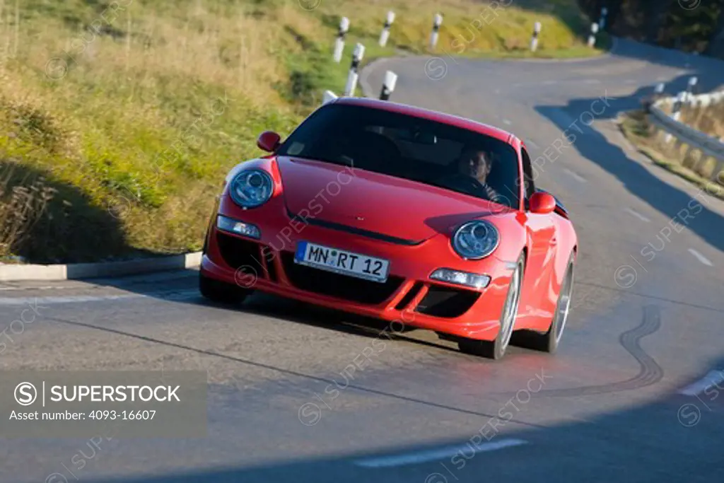 An action shot of a 2007 Ruf Porsche RT12. introduced the model in Fall 2004 at the Essen Motor Show as the first of their offerings built on Porsche's new 997 platform. A twin-turbocharged, 3.6 litre flat-six cylinder engine based on the previous 996 series Turbo engine provides 530 and 560 Bhp options while the bored-out 3.8 litre option produces 650 bhp. The Rt 12 features specially developed RUF bodywork, giving the vehicle a unique appearance while functioning to increase downforce, improvi