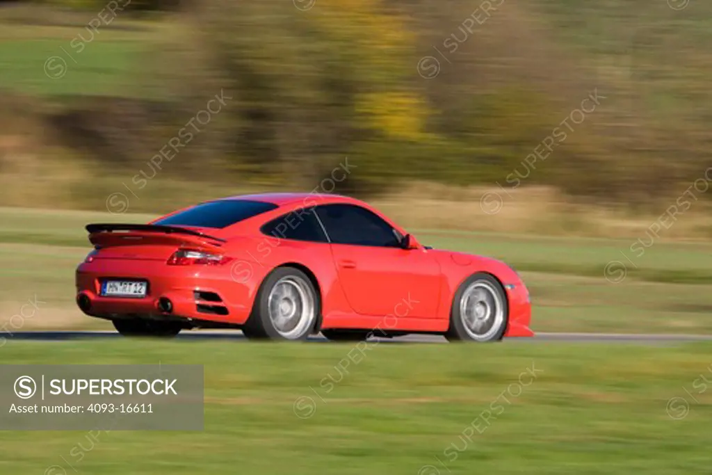 An action shot of a 2007 Ruf Porsche RT12. introduced the model in Fall 2004 at the Essen Motor Show as the first of their offerings built on Porsche's new 997 platform. A twin-turbocharged, 3.6 litre flat-six cylinder engine based on the previous 996 series Turbo engine provides 530 and 560 Bhp options while the bored-out 3.8 litre option produces 650 bhp. The Rt 12 features specially developed RUF bodywork, giving the vehicle a unique appearance while functioning to increase downforce, improvi