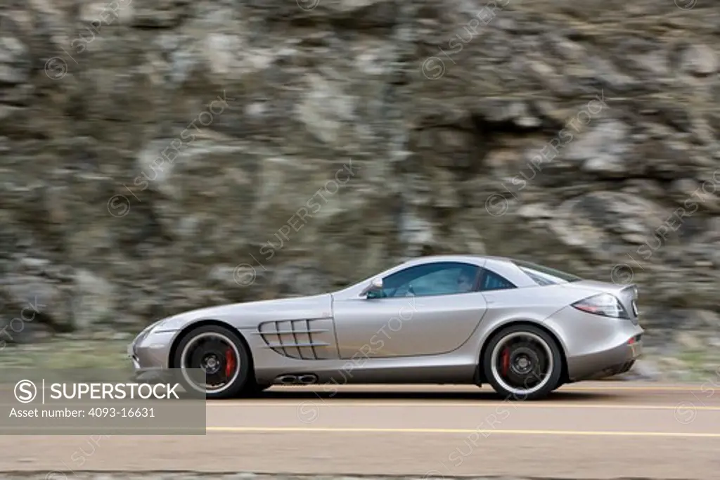 An action shot of a 2007 Mercedes-Benz McLaren SLR 722. The 722 refers to the victory by Stirling Moss and his co-driver Denis Jenkinson in a Mercedes-Benz 300 SLR with the starting number 722 (indicating a start time of 7:22 a.m.) at the Mille Miglia in 1955. The 722 Edition creates 650 bhp, with a top speed of 337 km/h (5 more than the standard SLR). A new suspension is used with 19-inch light-alloy wheels, a stiffer damper configuration and 0.4 inches lower body. The SLR is planned to end pro