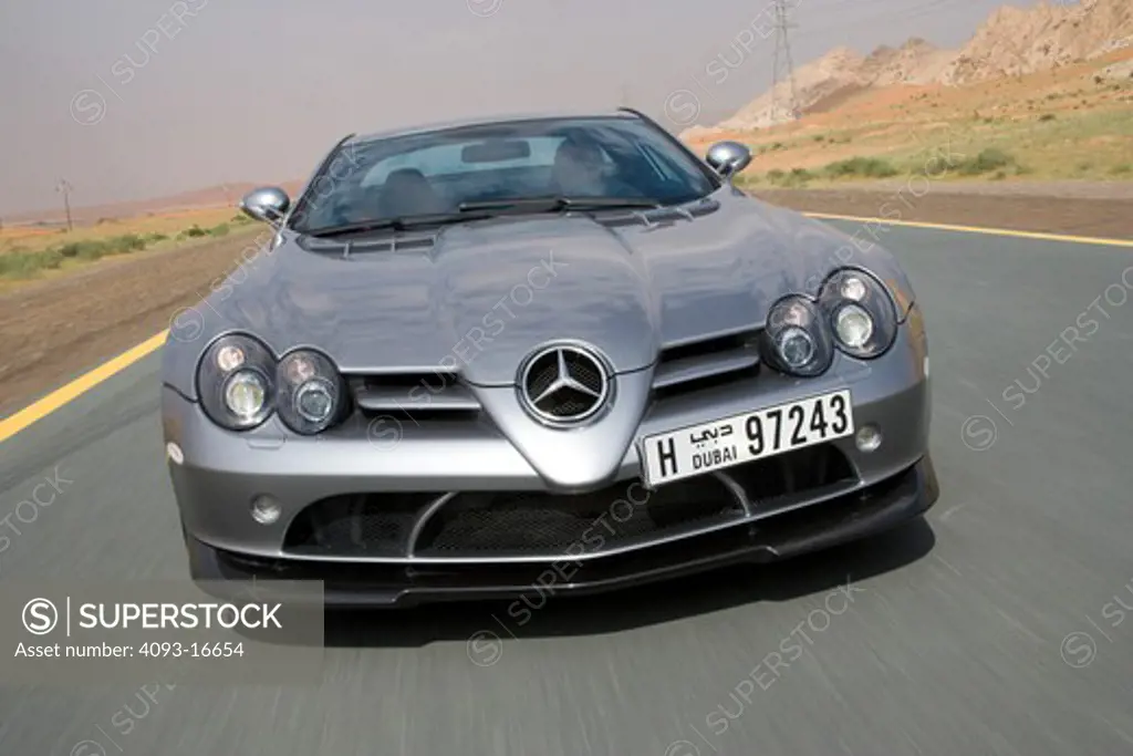 An action shot of a 2007 Mercedes-Benz McLaren SLR 722. The 722 refers to the victory by Stirling Moss and his co-driver Denis Jenkinson in a Mercedes-Benz 300 SLR with the starting number 722 (indicating a start time of 7:22 a.m.) at the Mille Miglia in 1955. The 722 Edition creates 650 bhp, with a top speed of 337 km/h (5 more than the standard SLR). A new suspension is used with 19-inch light-alloy wheels, a stiffer damper configuration and 0.4 inches lower body. The SLR is planned to end pro