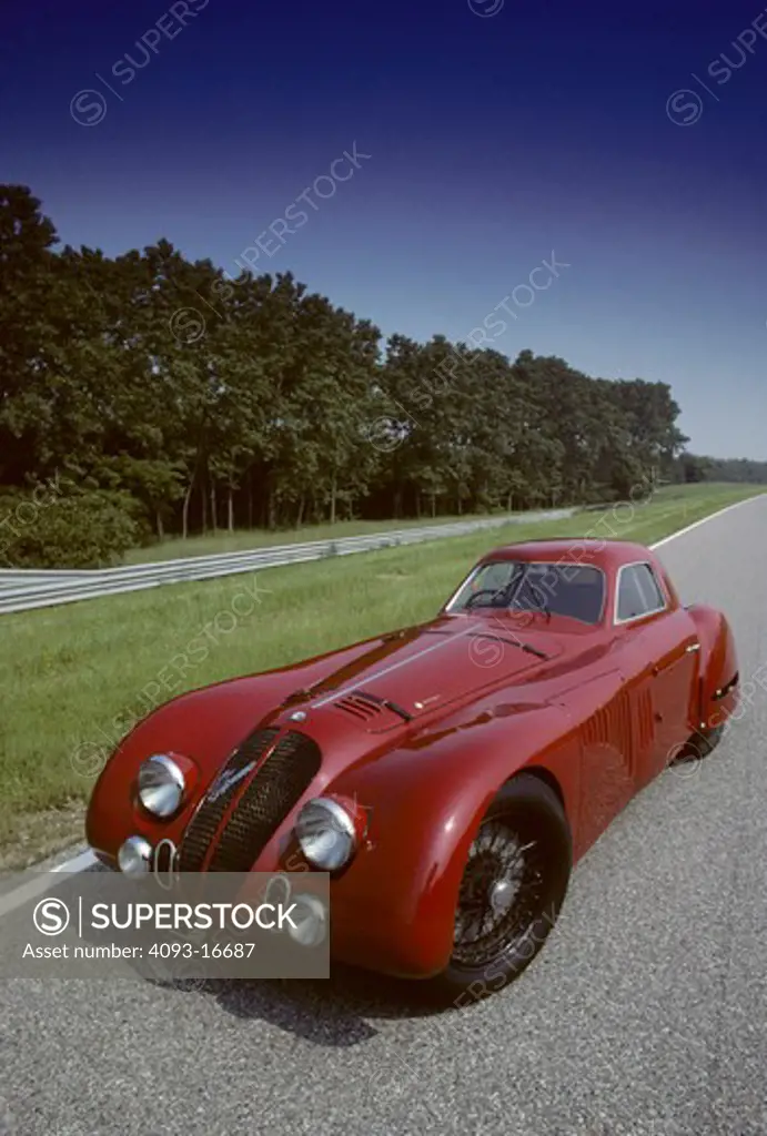 1938 AlfaRomeo 8C 2900B Touring Coupe beauty front 3/4. The rare and unique Alfa Romeo 8C 2900 B was designed in the 1930's for both racing and road use. It featured a 180 bhp version of the famous 8 cylinder Alfa Romeo engine originally designed by Vittorio Jano. This engine was installed in a box-type chassis available in short and long wheel base configurations, both with all-round independent suspension. Most of the 33 8C 2900Bs built were fitted with lightweight Touring bodies, constructed 