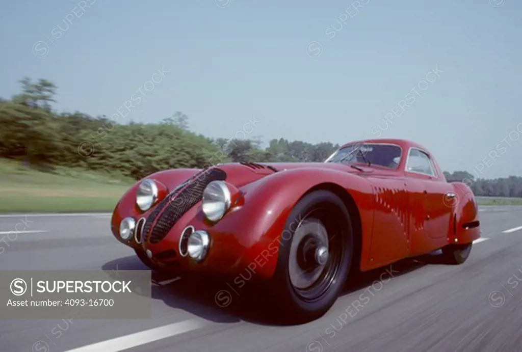 1938 Alfa Romeo 8C 2900B Touring Coupe action front 3/4. The rare and unique Alfa Romeo 8C 2900 B was designed in the 1930's for both racing and road use. It featured a 180 bhp version of the famous 8 cylinder Alfa Romeo engine originally designed by Vittorio Jano. This engine was installed in a box-type chassis available in short and long wheel base configurations, both with all-round independent suspension. Most of the 33 8C 2900Bs built were fitted with lightweight Touring bodies, constructed