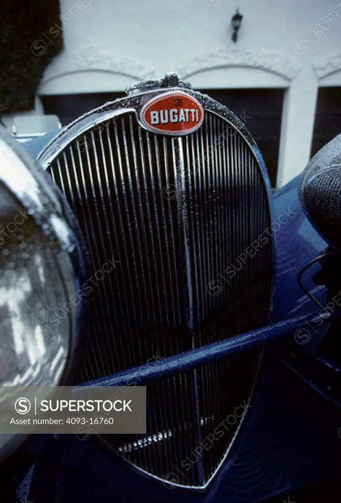 1936 Bugatti Type 57S Roadster beauty nose detail. The Type 57 S / SC is one of the best-known Bugatti cars. The S stood for surbaissé (lowered), though most felt it stood for sport. It included a v-shaped dip at the bottom of the radiator and mesh grilles on either side of the engine compartment.  Lowering the car was a major undertaking. The rear axle now passed through the rear frame rather than riding under it, and a dry-sump lubrication system was required to fit the engine under the new