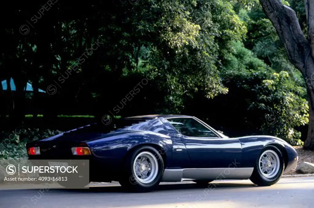 1969 Lamborghini Miura rear 3/4 beauty. The Lamborghini Miura P400S is a sports car built in Italy by Lamborghini between 1966 and 1973. A mid-engined layout had been used successfully in competition. The Miura was a trendsetter, the one that made the mid-engined layout de rigueur among two-seater high performance supercars. It is named after the Spanish ranch Miura, whose bulls have a proverbial attack instinct.