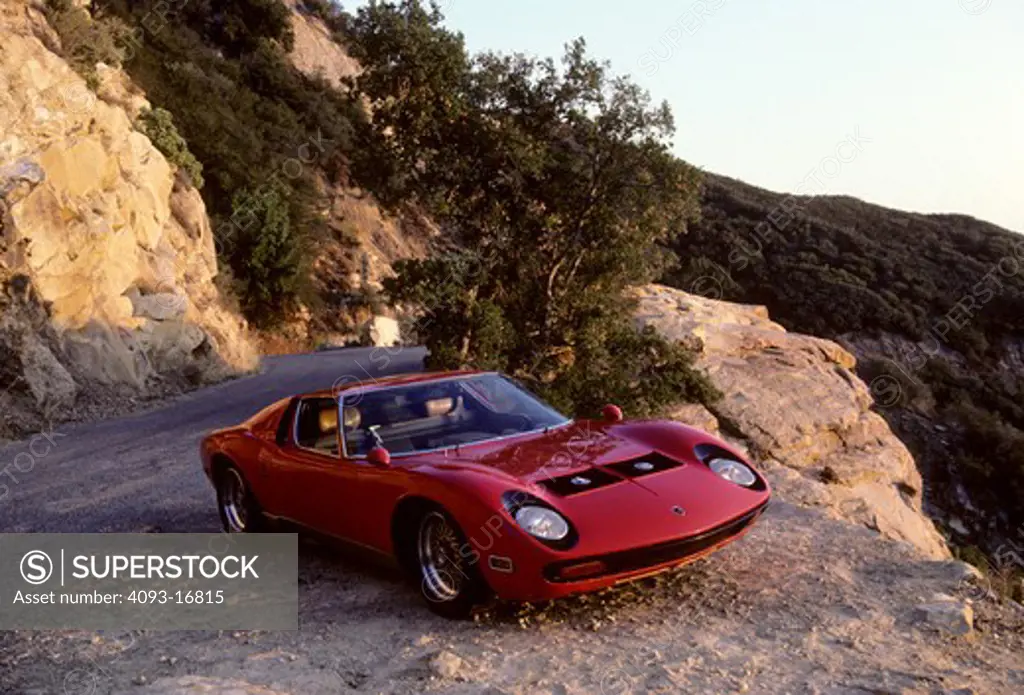 1970 Lamborghini Miura front 3/4 beauty. The Lamborghini Miura P400S is a sports car built in Italy by Lamborghini between 1966 and 1973. A mid-engined layout had been used successfully in competition. The Miura was a trendsetter, the one that made the mid-engined layout de rigueur among two-seater high performance supercars. It is named after the Spanish ranch Miura, whose bulls have a proverbial attack instinct.