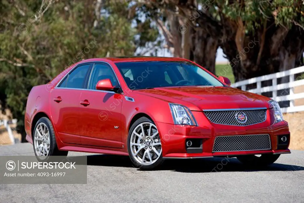 2009 Cadillac CTS-V red outdoors on a ranch.  The Cadillac CTS-V is a model in Cadillac's V-Series line of high performance vehicles