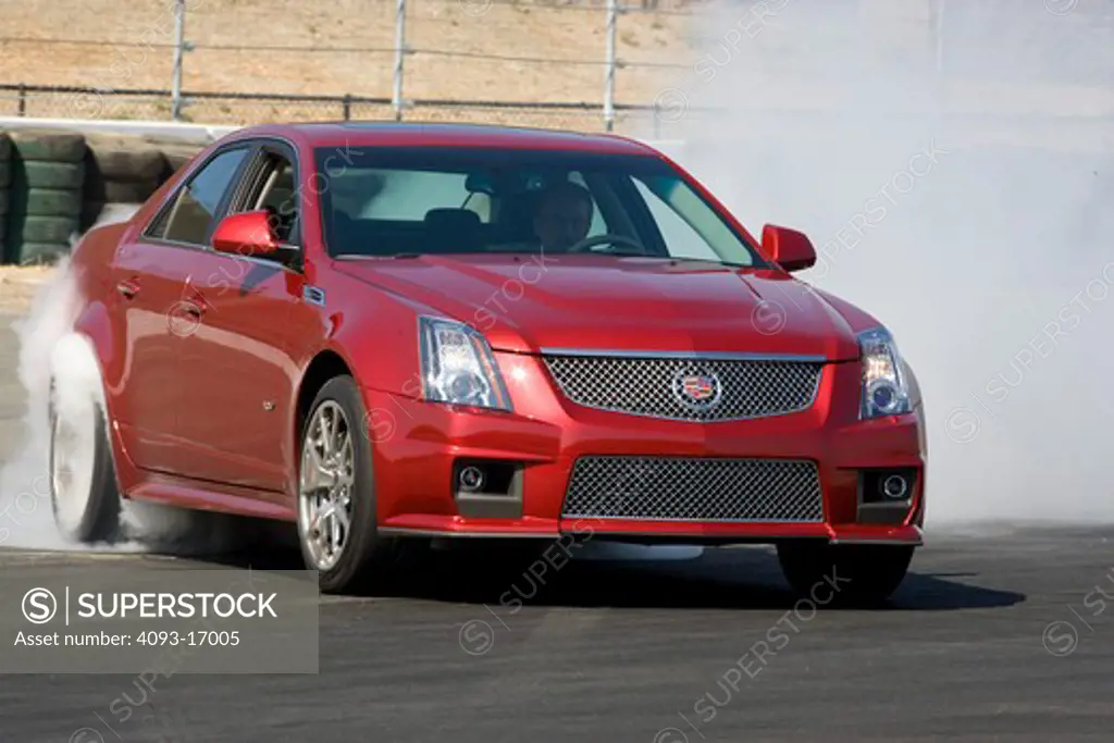 2009 Cadillac CTS-V red outdoors on a ranch.  The Cadillac CTS-V is a model in Cadillac's V-Series line of high performance vehicles