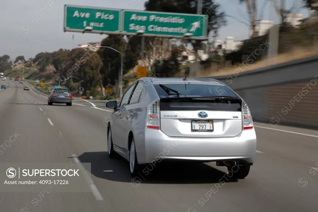 Rear 3/4 view of a 2010 Toyota Prius Hybrid on a freeway interstate highway
