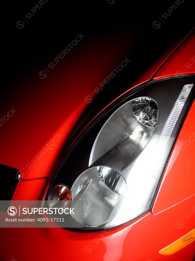 2005 red Infiniti G35 Sport Coupe headlight detail.