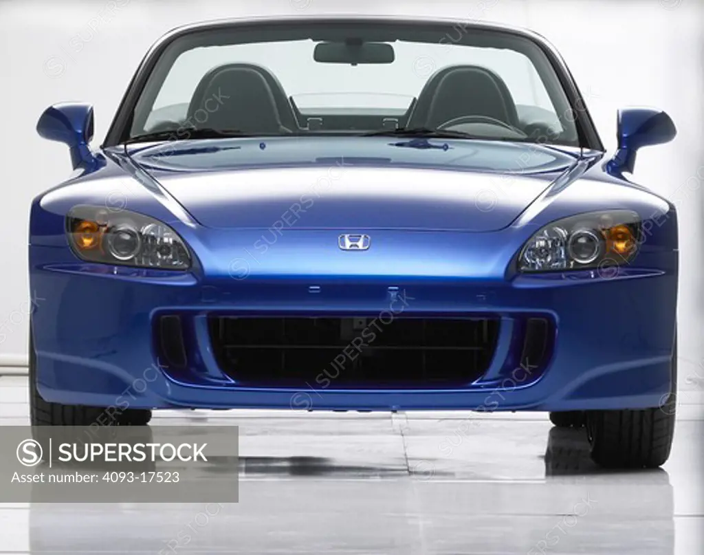 Nose view of a blue 2006 Honda S2000 photographed in the studio with a white background.