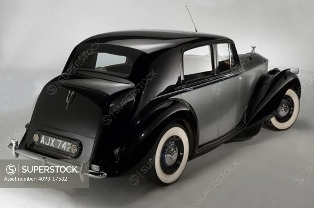 Rear 3/4 view of a black and silver 1949 Rolls Royce Silver Dawn.