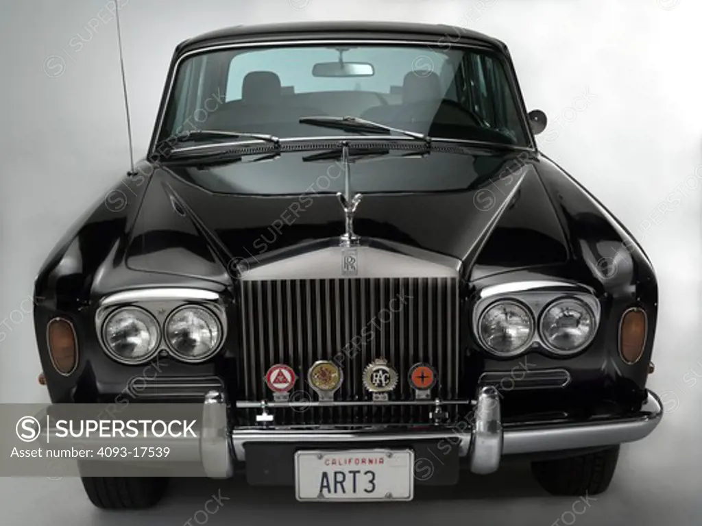 Front nose view of a black 1972 Rolls Royce Silver Shadow luxury sedan photographed in the studio with a white background.