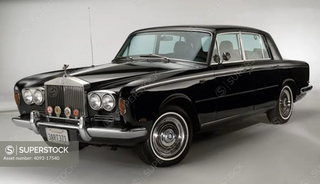 Front 3/4 view of a black 1972 Rolls Royce Silver Shadow luxury sedan photographed in the studio with a white background.