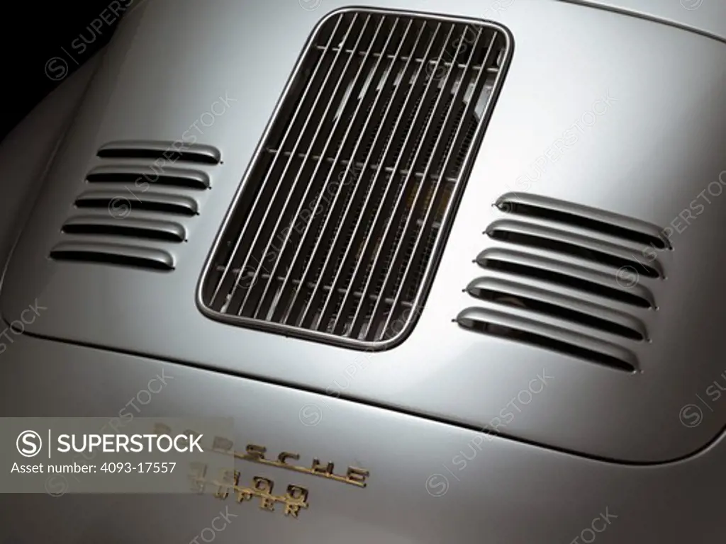 Rear engine cover view of a silver 1958 Porsche 356GT showing the badge detail.
