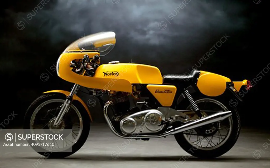 Profile view of a Yellow 1970 Norton Commando 750 Production Racer race bike. Photographed in the studio.