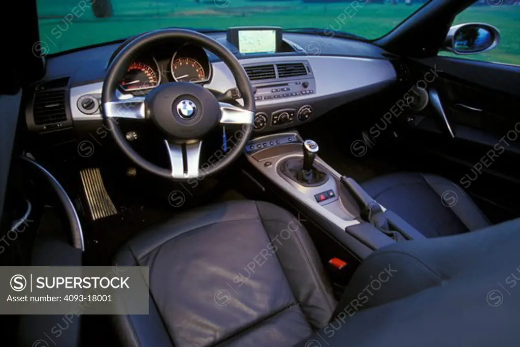interior detail BMW 3 Series 2003 leather seats black steering wheel navigation silver dashboard gear shift emergency brake gauges