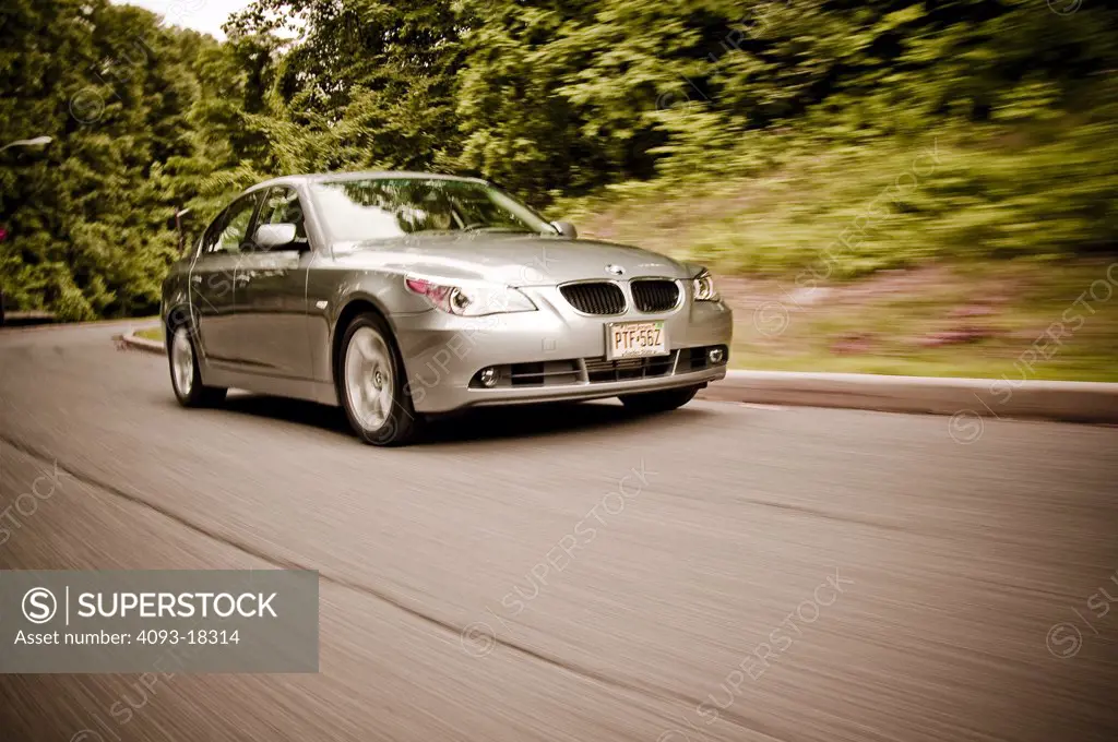 BMW 2005 5 series 5-series in motion driving down the mountains on a curved curvy road