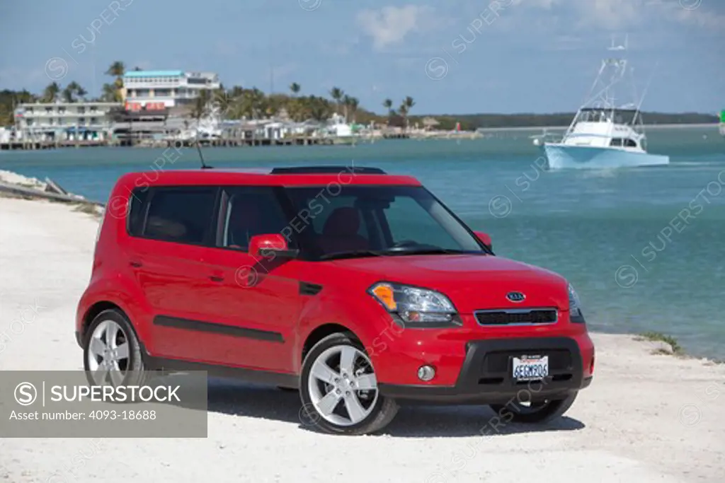 Front 3/4 static view of 2010 red Kia Soul at the beach