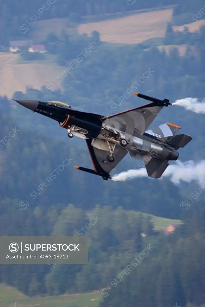 Red Bull Airshow over Salzberg, Austria home of Red Bull and their aviation museum. Shown is a wildly decorated Lockheed Martin F-16 Fighting Falcon. In flight flying