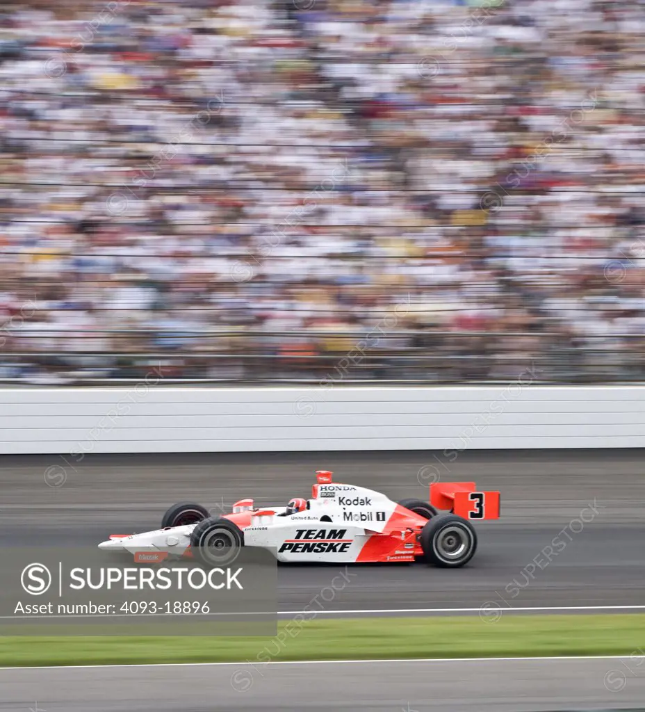 formula one race car f1 f-1  team Penske racing speeding by